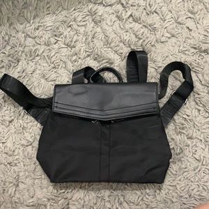Black mini backpack/bag and a magnet button to close with zippers